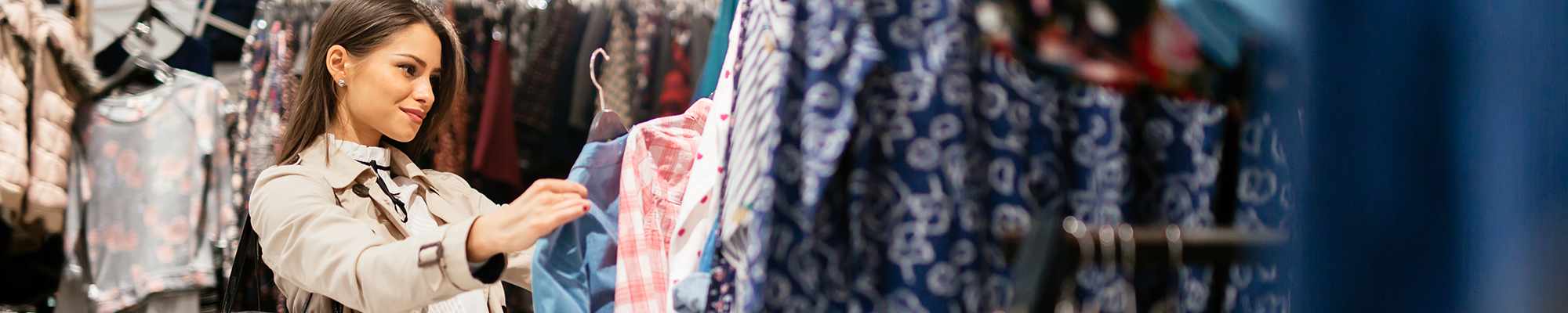 woman-looking-at-dresses-in-store-2000x400