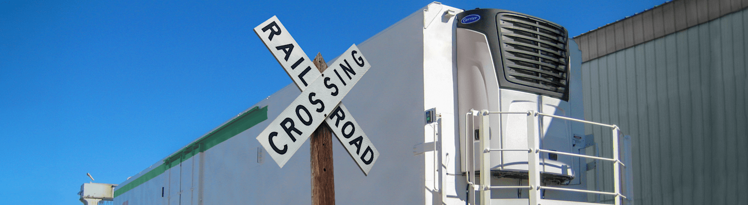 Carrier Transicold Intermodal and Rail Refrigeration Units - Vector Rail Unit at Railroad Crossing Sign