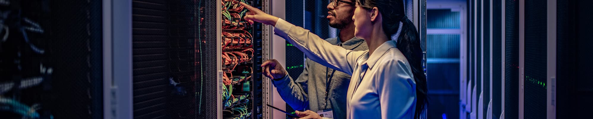 man-woman-in-data-center-2000x550