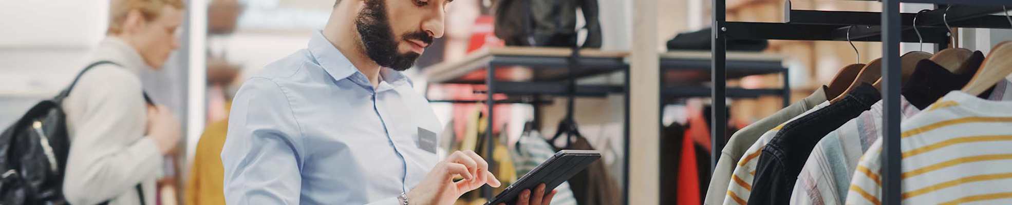 man-using-tablet-in-retail-store-2-2000x400