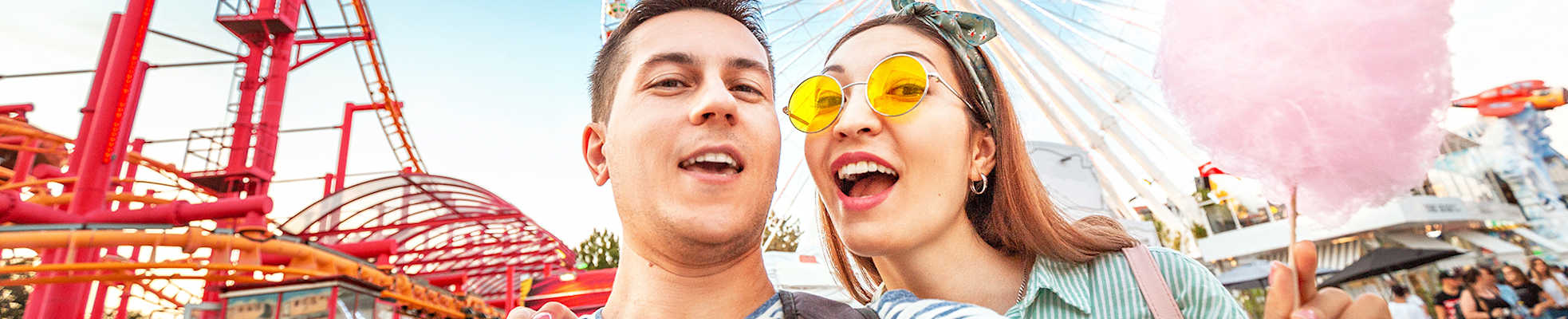 man-woman-enjoying-amusement-park-hero