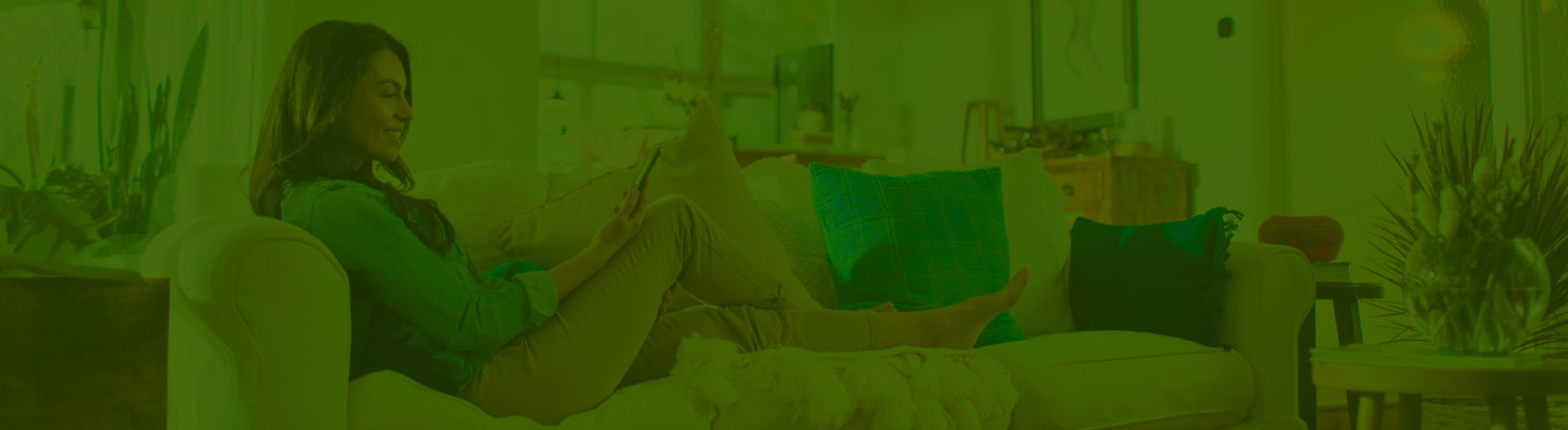 woman-looking-at-phone-in-living-room-green-layer