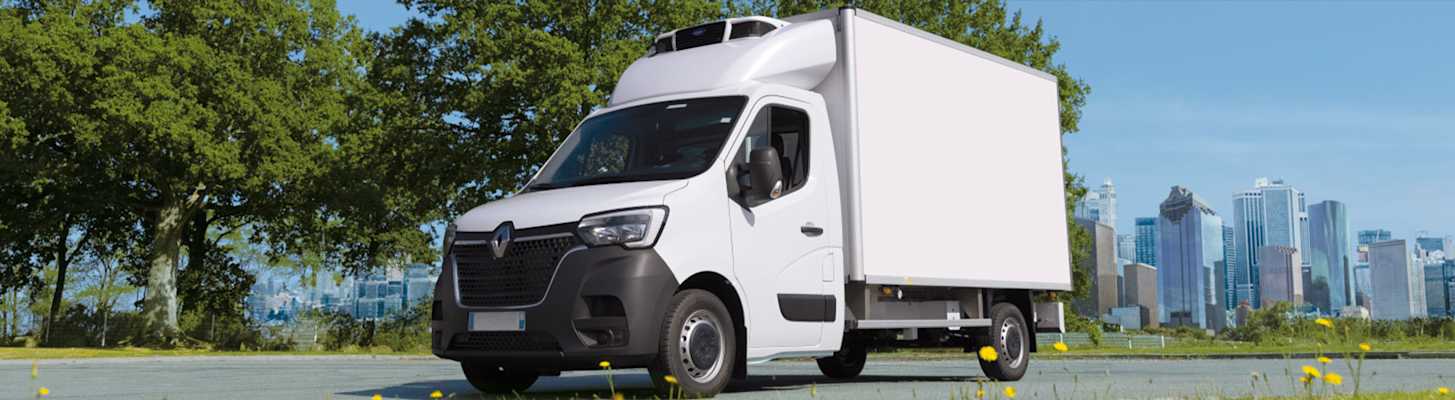 White truck with Carrier Pulsor LCV Refrigeration Unit with trees and city skyline in background
