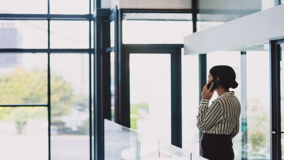 woman-on-phone-integrity-line-hero-image-anonymous-reporting-16x9