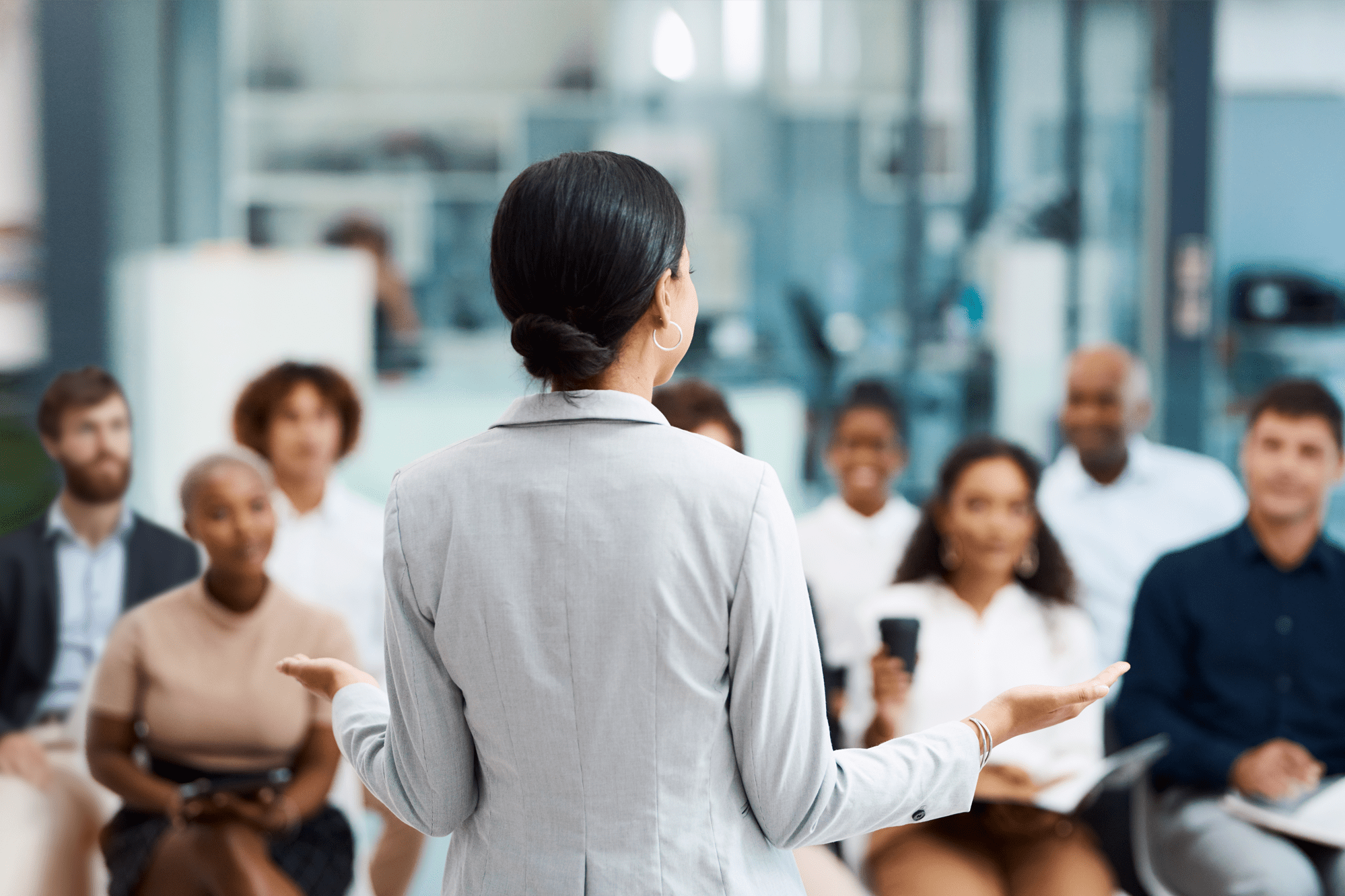 Female business woman presenting to group