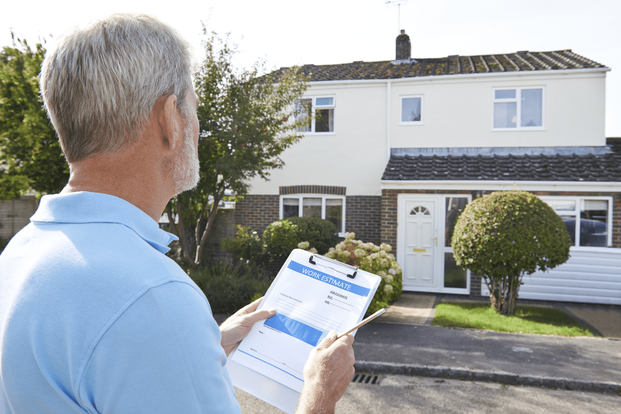 Male taking notes outside exterior of house