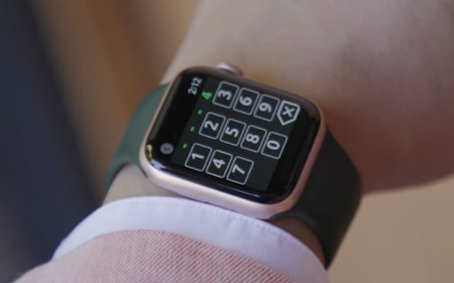 Close up of Apple watch on wrist with eKEY app obtain key.