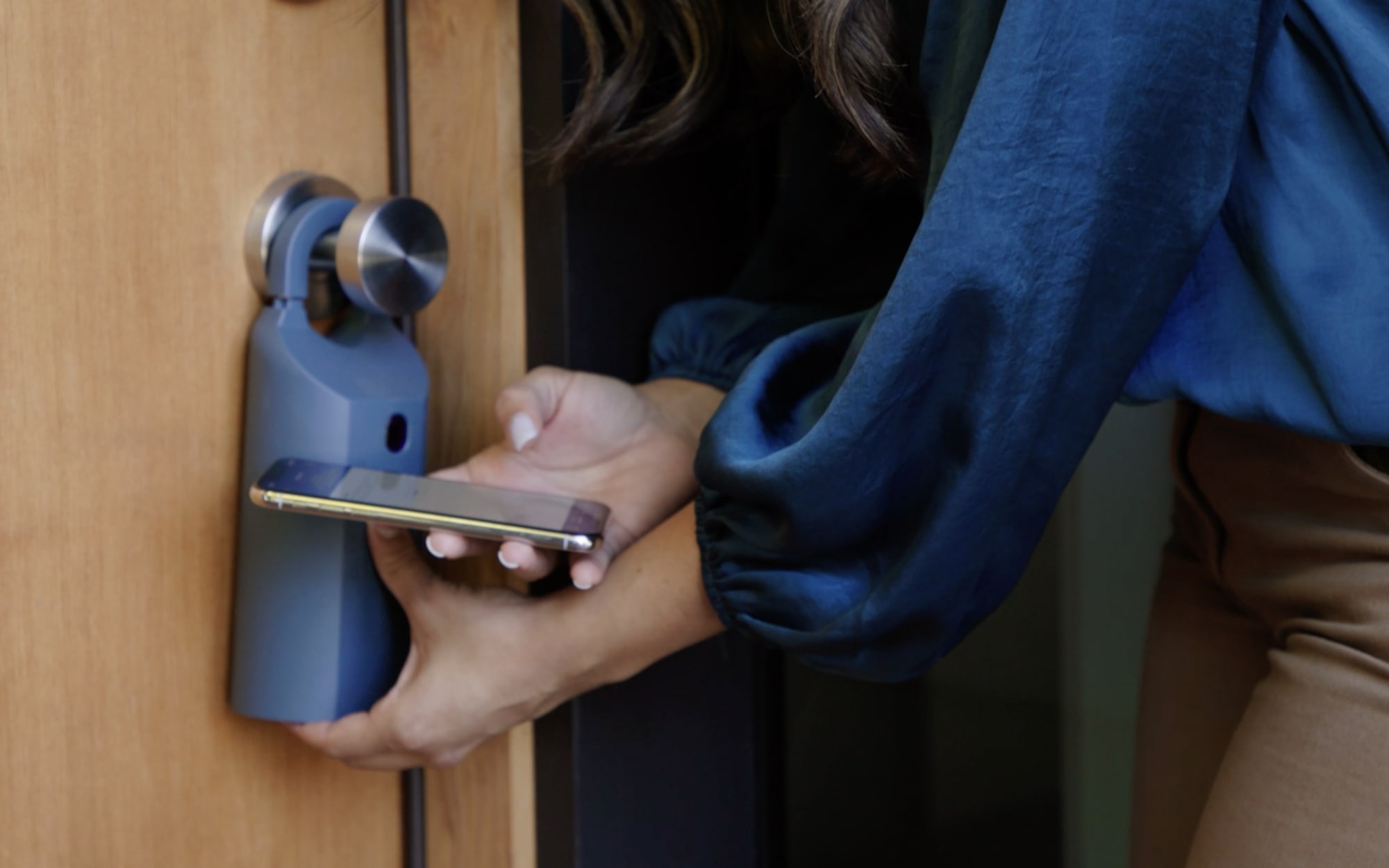 Real estate agent using mobile app to open lockbox on home for sale.