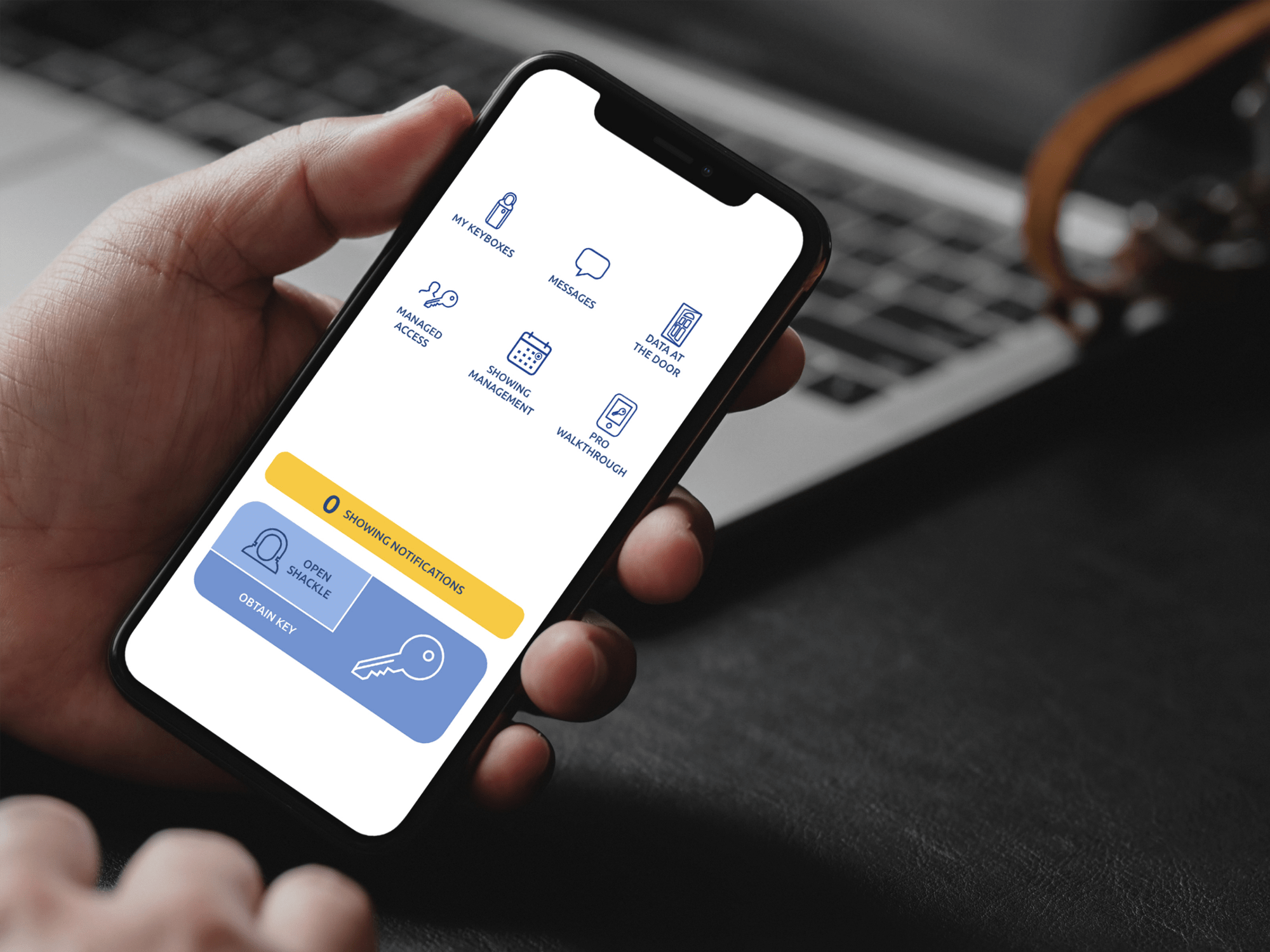 Hands on desk close up of eKEY app home screen.