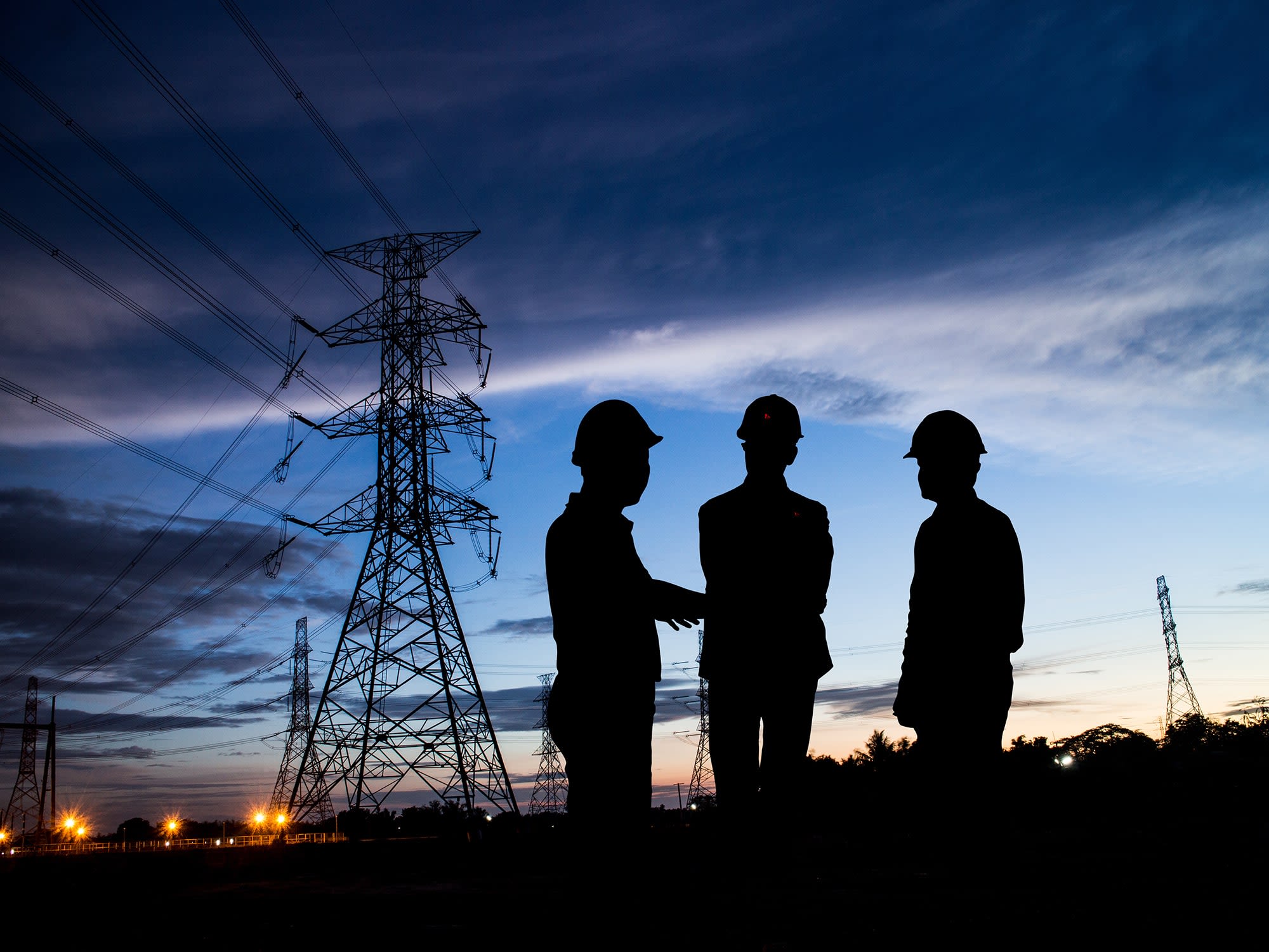 silhouette-man-of-engineers-standing-at-electricity-station-over