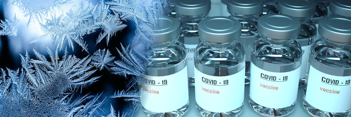 Closeup of COVID-19 vaccine vials against background ice crystals
