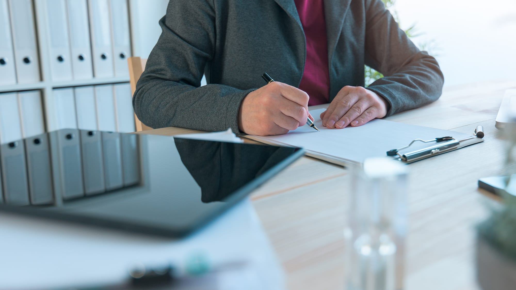 person-writing-on-notepad-16x9