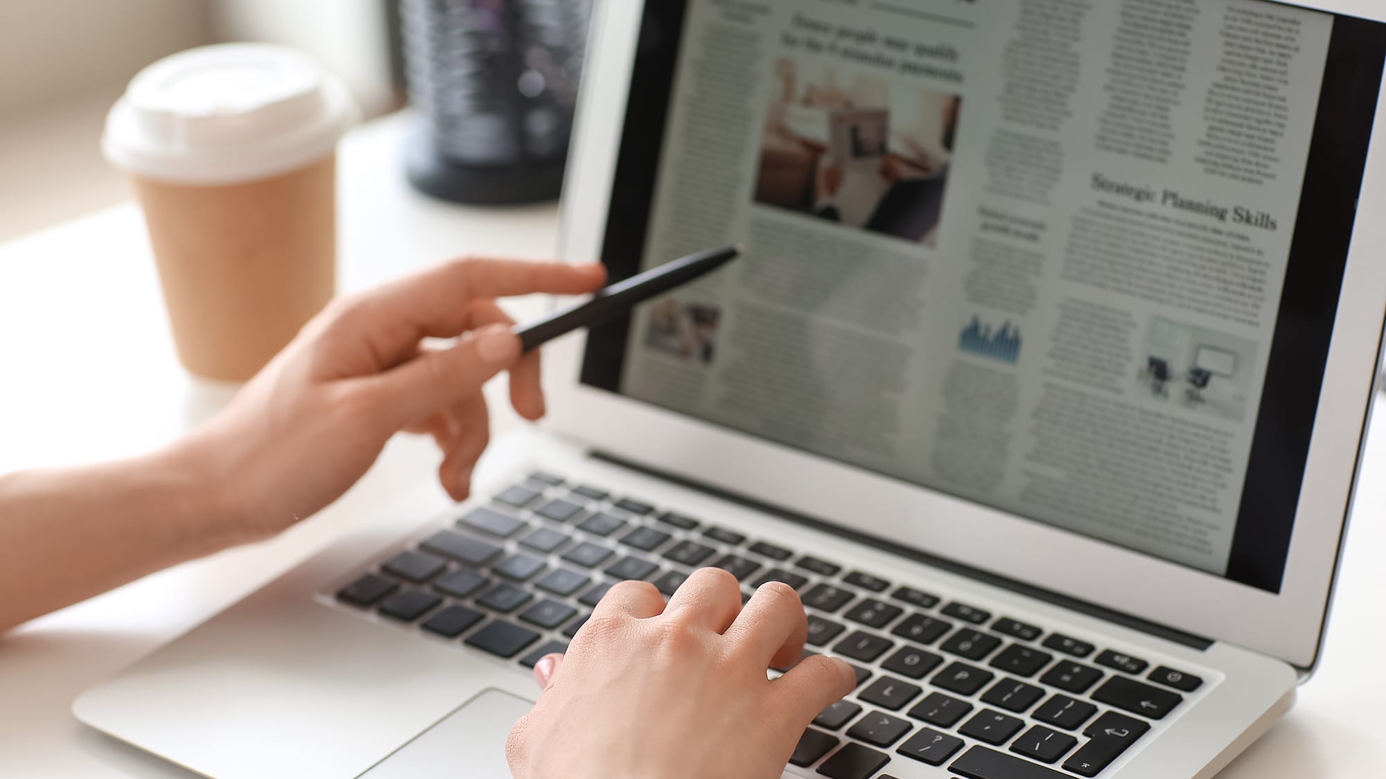 person-looking-at-news-on-laptop-16x9