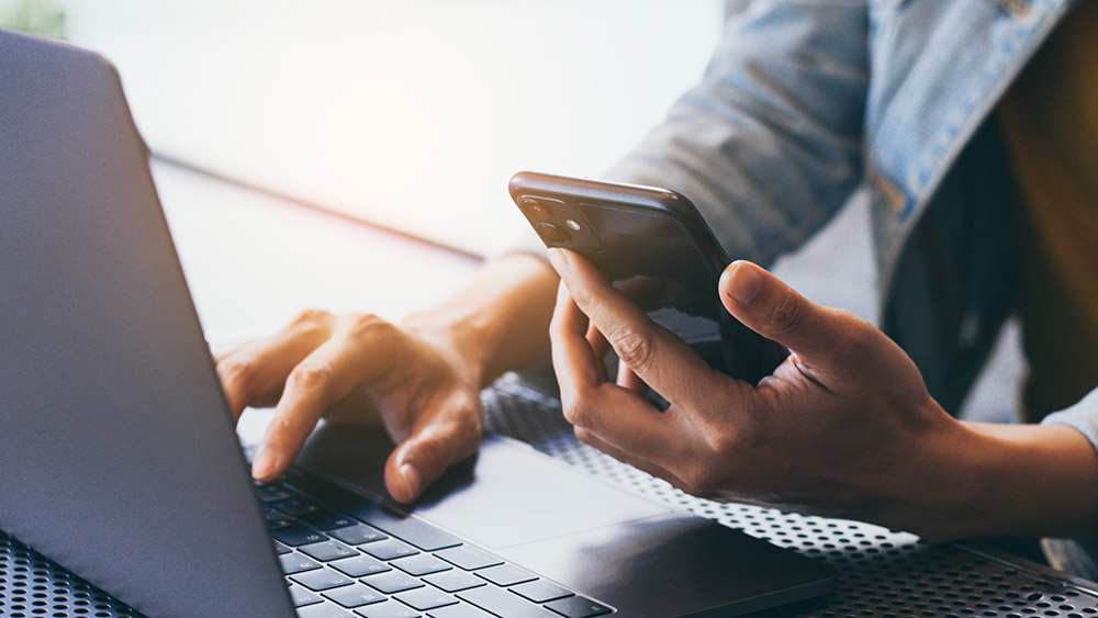 woman-on-phone-laptop-16x9